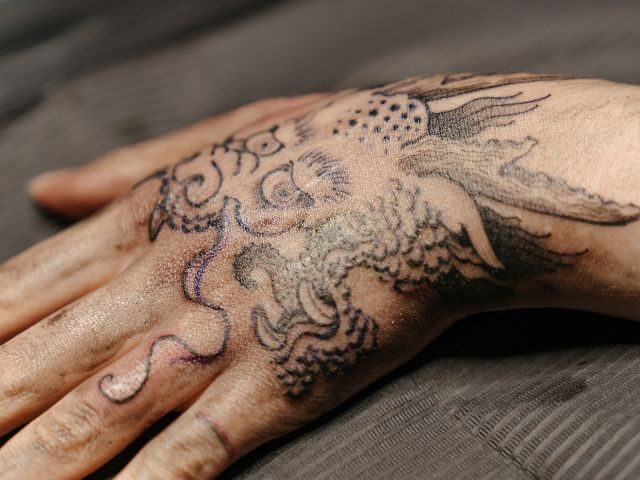 Fine line dotwork tattoo on a hand